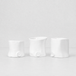 Three handmade Montes Doggett ceramic appetizer bowls in creamy white glaze.
