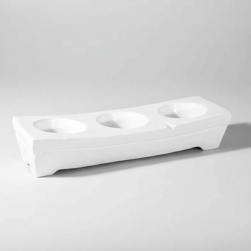 White ceramic appetizer platform by Montes Doggett, 17.25"L, with three round dip wells.