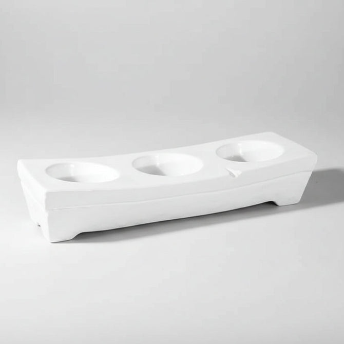 White ceramic appetizer platform by Montes Doggett, 17.25"L, with three round dip wells.