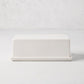 White ceramic butter dish with a sleek rectangular lid and tray.