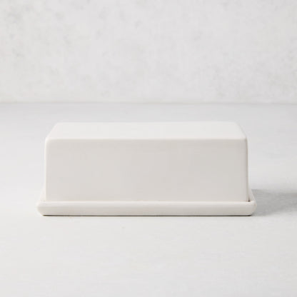 White ceramic butter dish with a sleek rectangular lid and tray.