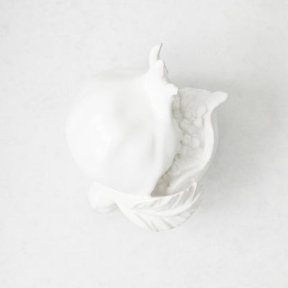 Handmade white glazed ceramic pomegranate decorative sculpture with artisanal details, 11 inches long.