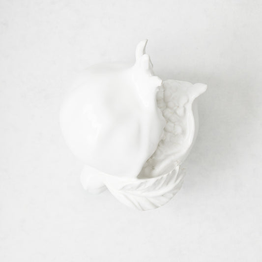 Handmade white glazed ceramic pomegranate decorative sculpture with artisanal details, 11 inches long.