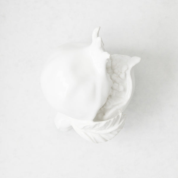 Handmade white glazed ceramic pomegranate decorative sculpture with artisanal details, 11 inches long.