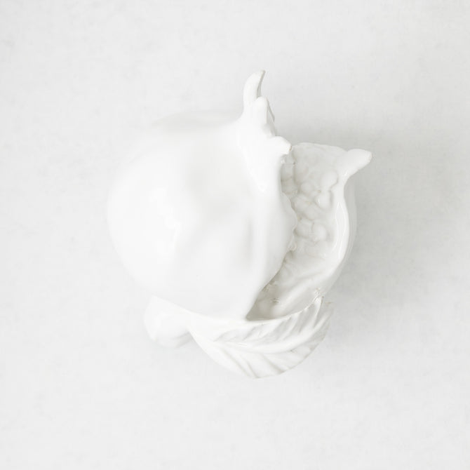 Handmade white glazed ceramic pomegranate decorative sculpture with artisanal details, 11 inches long.