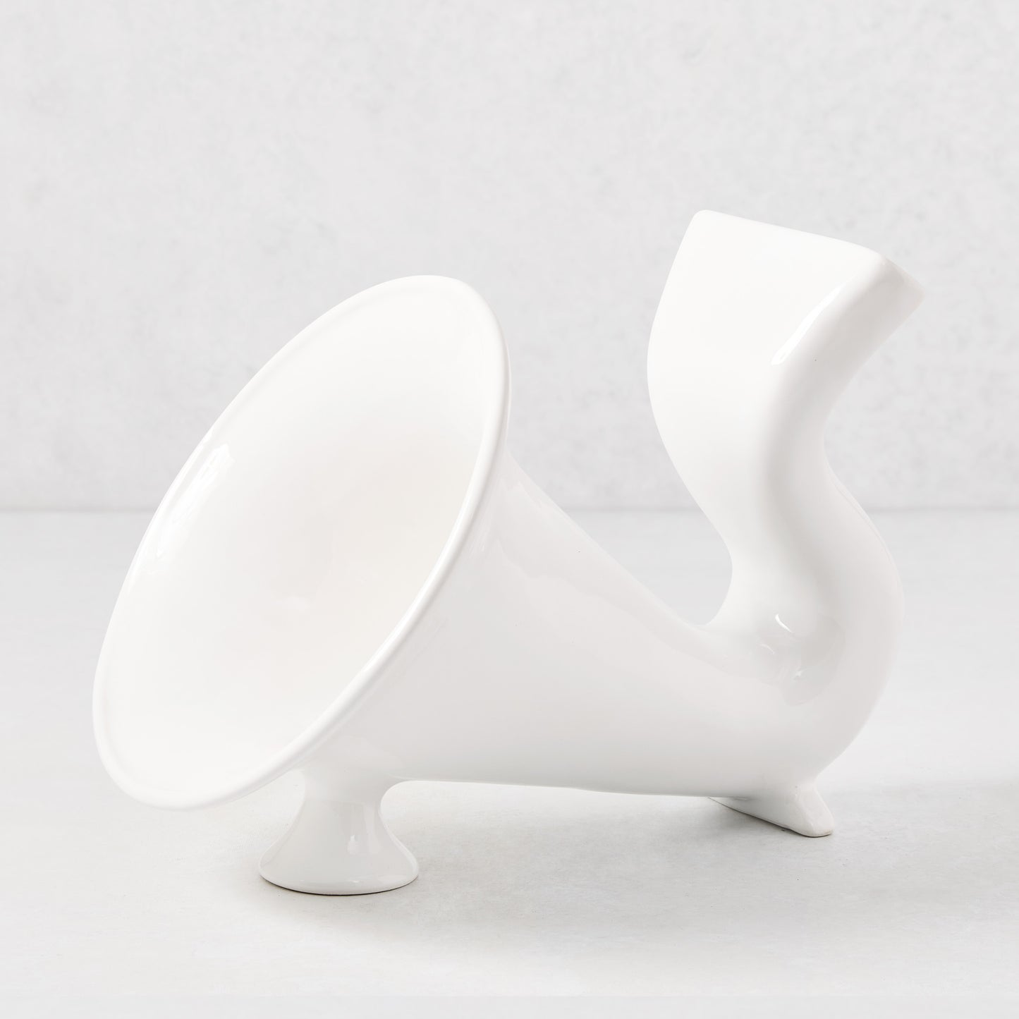 White ceramic kitchen speaker, 10"L x 7.25"W x 7.5"H, with a horn shape and phone slot.