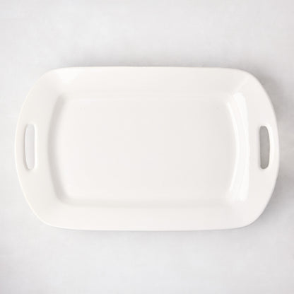 White ceramic serving platter with elegant handles, 13"W x 21"L, high-fired earthenware.