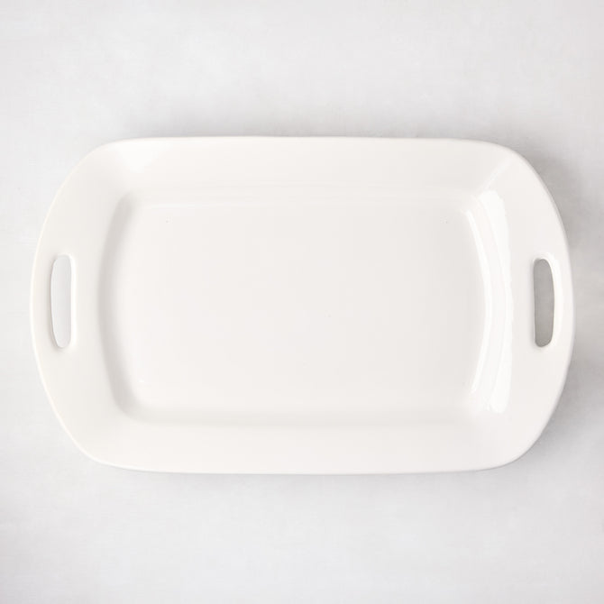 White ceramic serving platter with elegant handles, 13"W x 21"L, high-fired earthenware.