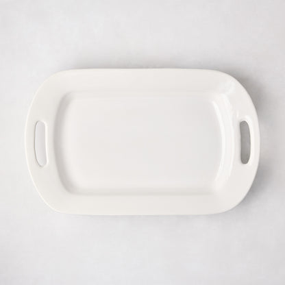 White ceramic serving platter with handles, 11"W x 18"L, from HG Ceramic Medium collection.