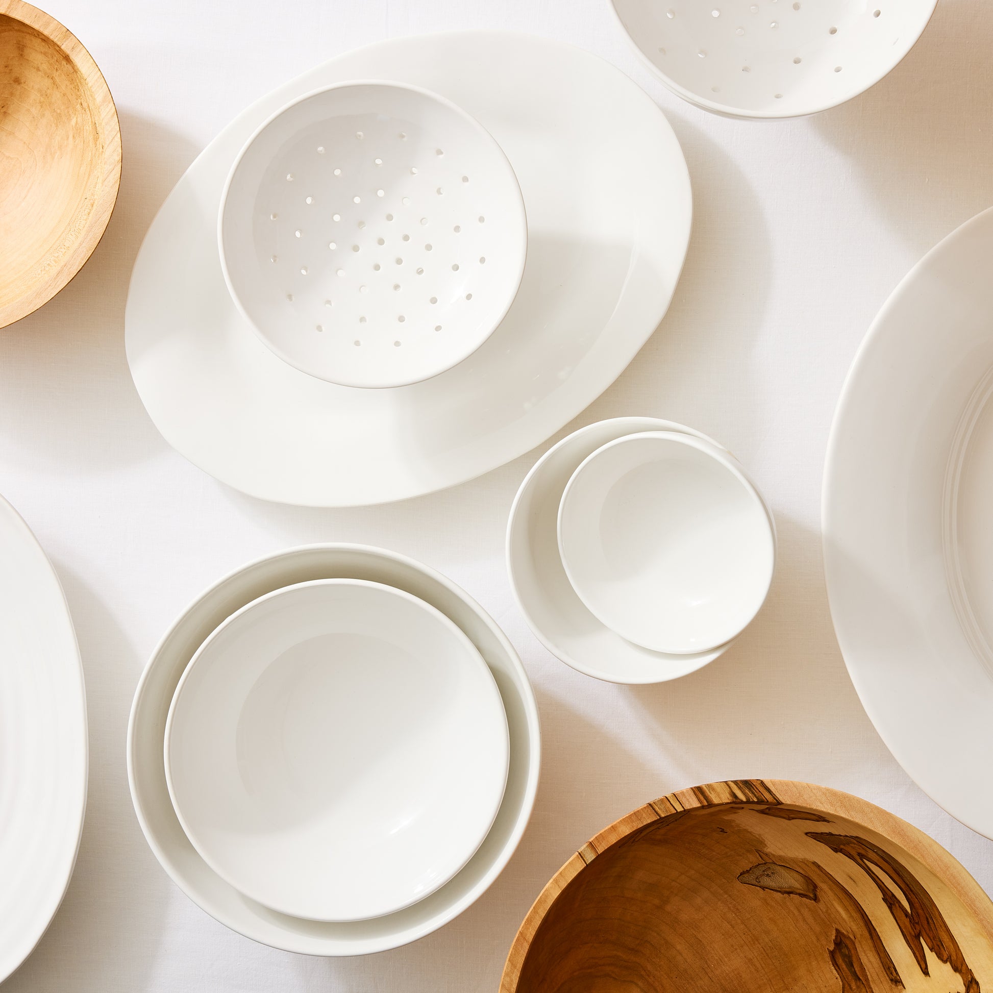 Set of 4 white ceramic nesting serve bowls, handmade in Italy, for salads, pastas, and snacks.