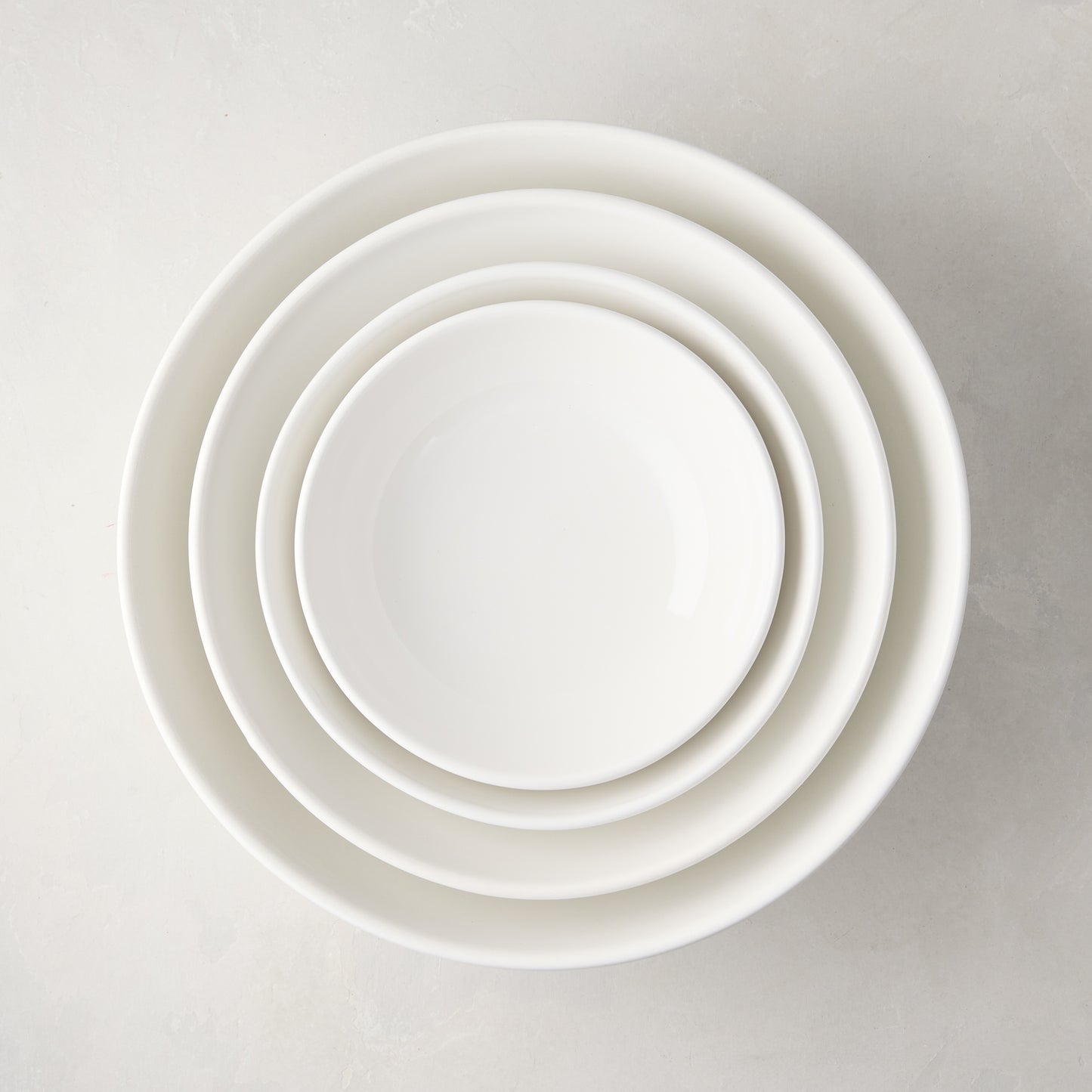 Set of 4 white ceramic nesting serve bowls, handmade in Italy.