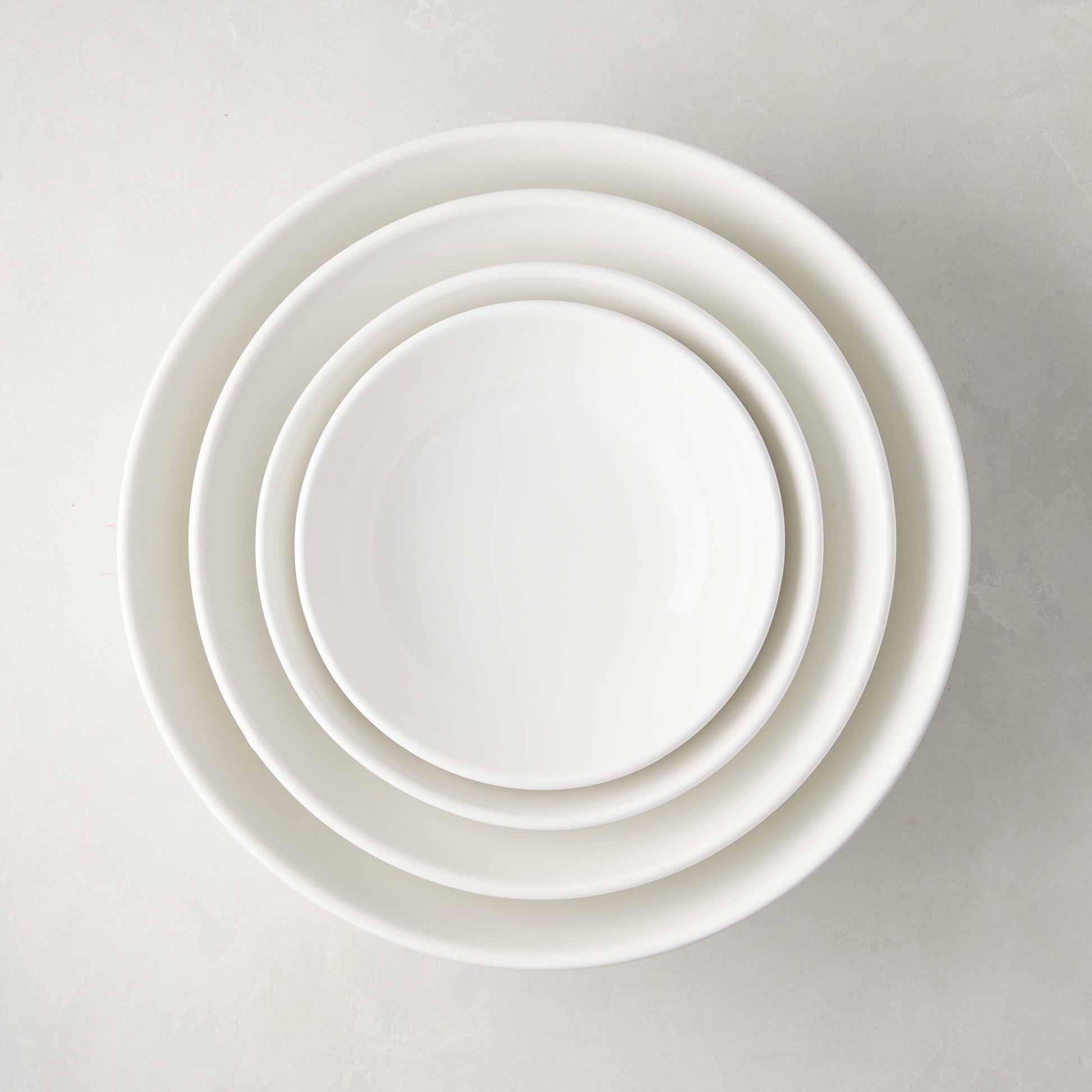Set of 4 white ceramic nesting serve bowls, handmade in Italy.