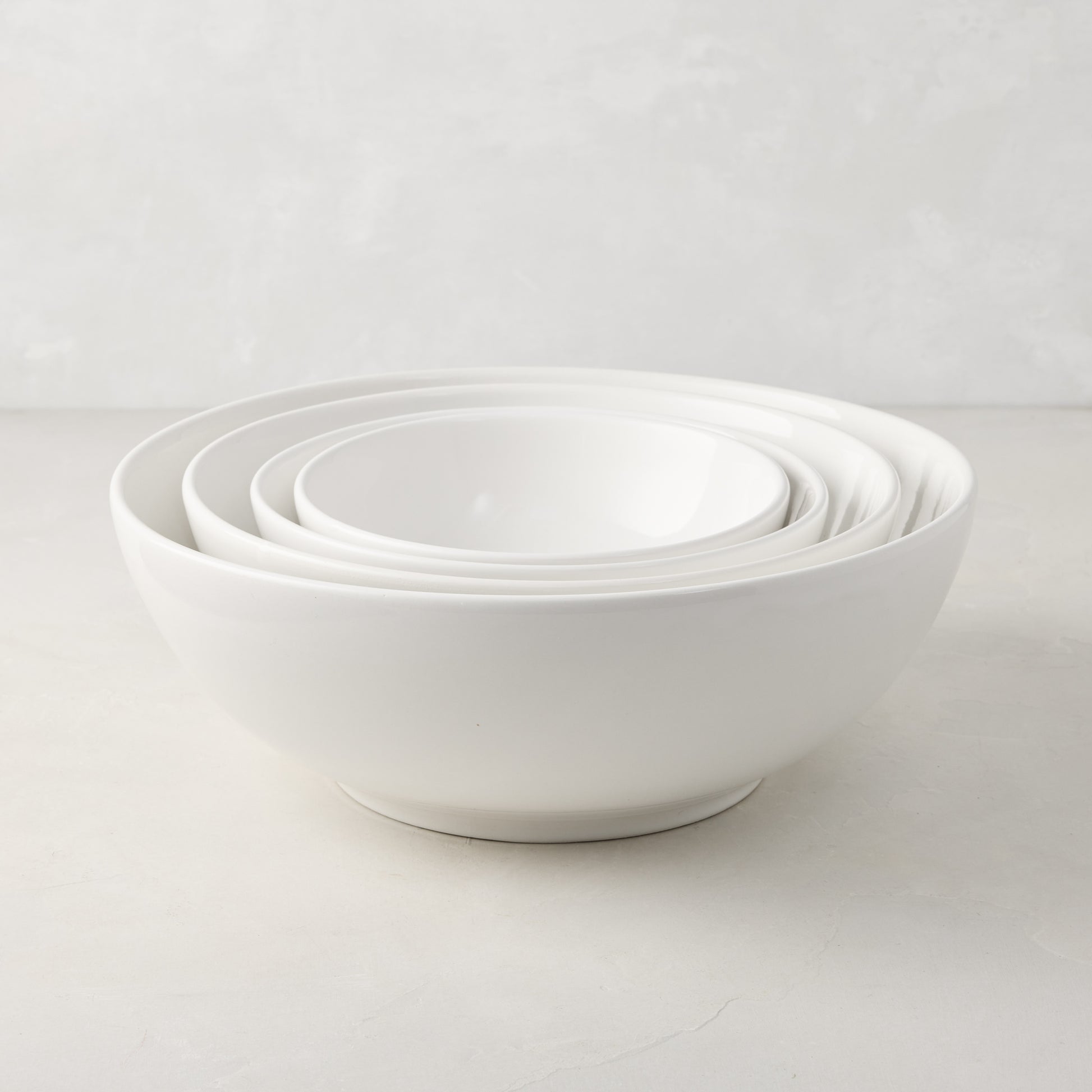 Set of 4 white ceramic nesting serve bowls, handmade in Italy, for salads, pastas, and snacks.