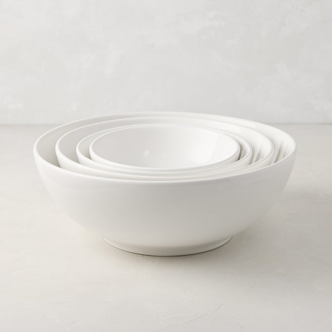 Set of 4 white ceramic nesting serve bowls, handmade in Italy, for salads, pastas, and snacks.
