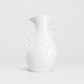 Creamy white ceramic pitcher by Montes Doggett, 14"H, with two round handles and a spout.