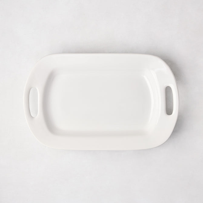 White ceramic small handled serving platter, 15"L x 9"W, with elegant handles.