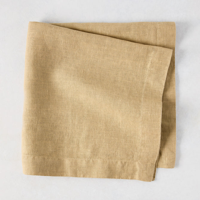 Chai HG Signature hand-dyed linen napkin, 22-inch square, creamy nutmeg color, folded.