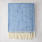 Chambray blue Italian herringbone throw blanket with cream fringe, 51"W x 67"L, 50% cotton, 50% acrylic.