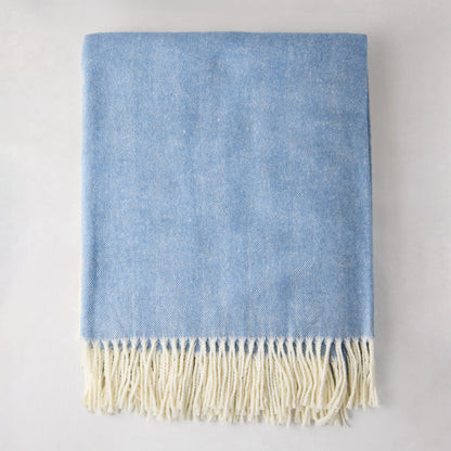 Chambray blue Italian herringbone throw blanket with cream fringe, 51"W x 67"L, 50% cotton, 50% acrylic.