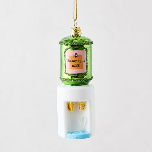 Mouth-blown glass and resin champagne cooler ornament with green bottle, pink label, and white water dispenser base.