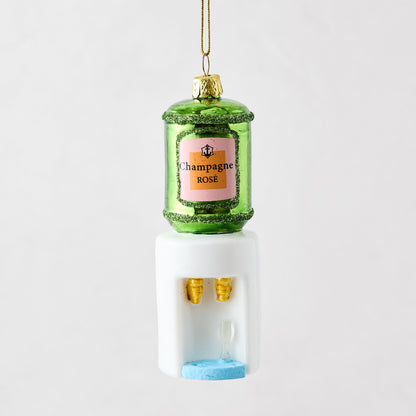 Mouth-blown glass and resin champagne cooler ornament with green bottle, pink label, and white water dispenser base.