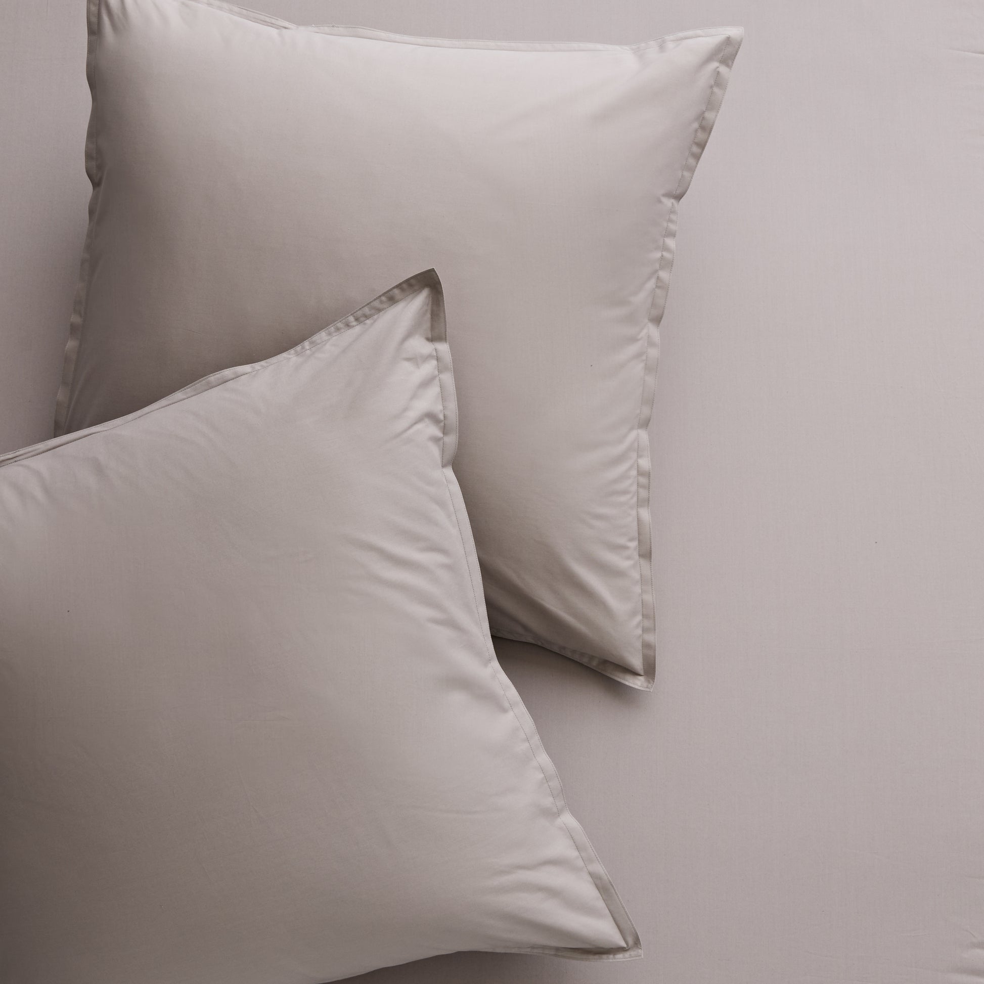 Two Charcoal Grey Italian Percale Euro Shams with envelope closures, shown on matching bedding.