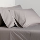 Charcoal Grey Italian Percale Sheet Set with two pillowcases on a bed.