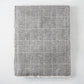 Charcoal grey Sutton Houndstooth throw blanket, 51"W x 67"L, cotton-acrylic blend with raw edge.