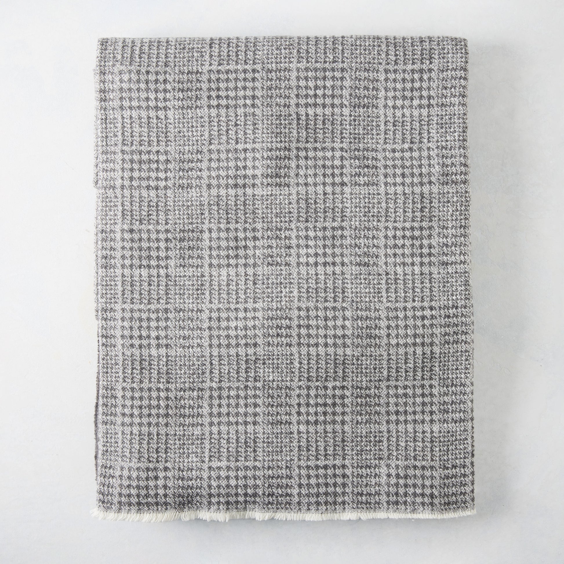 Charcoal grey Sutton Houndstooth throw blanket, 51"W x 67"L, cotton-acrylic blend with raw edge.