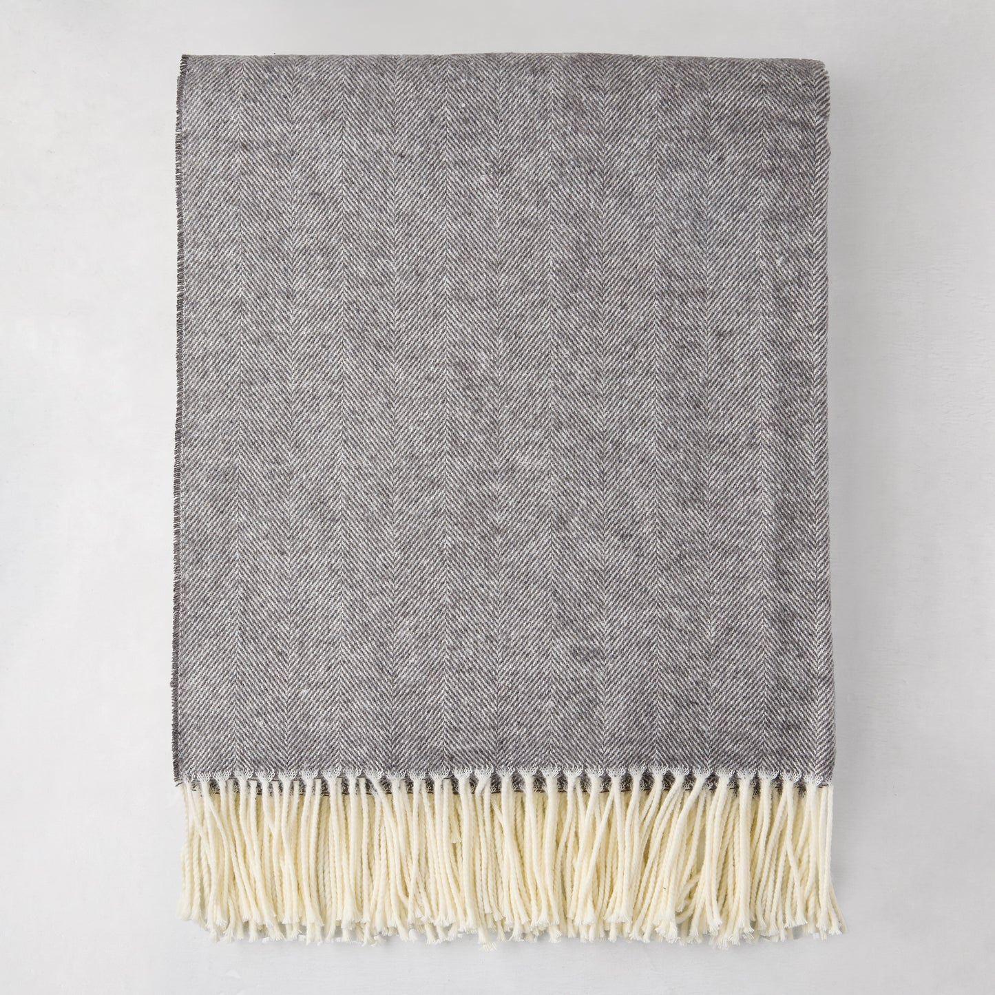 Charcoal Italian Herringbone Throw Blanket, 51"x67", with cream fringe, folded.