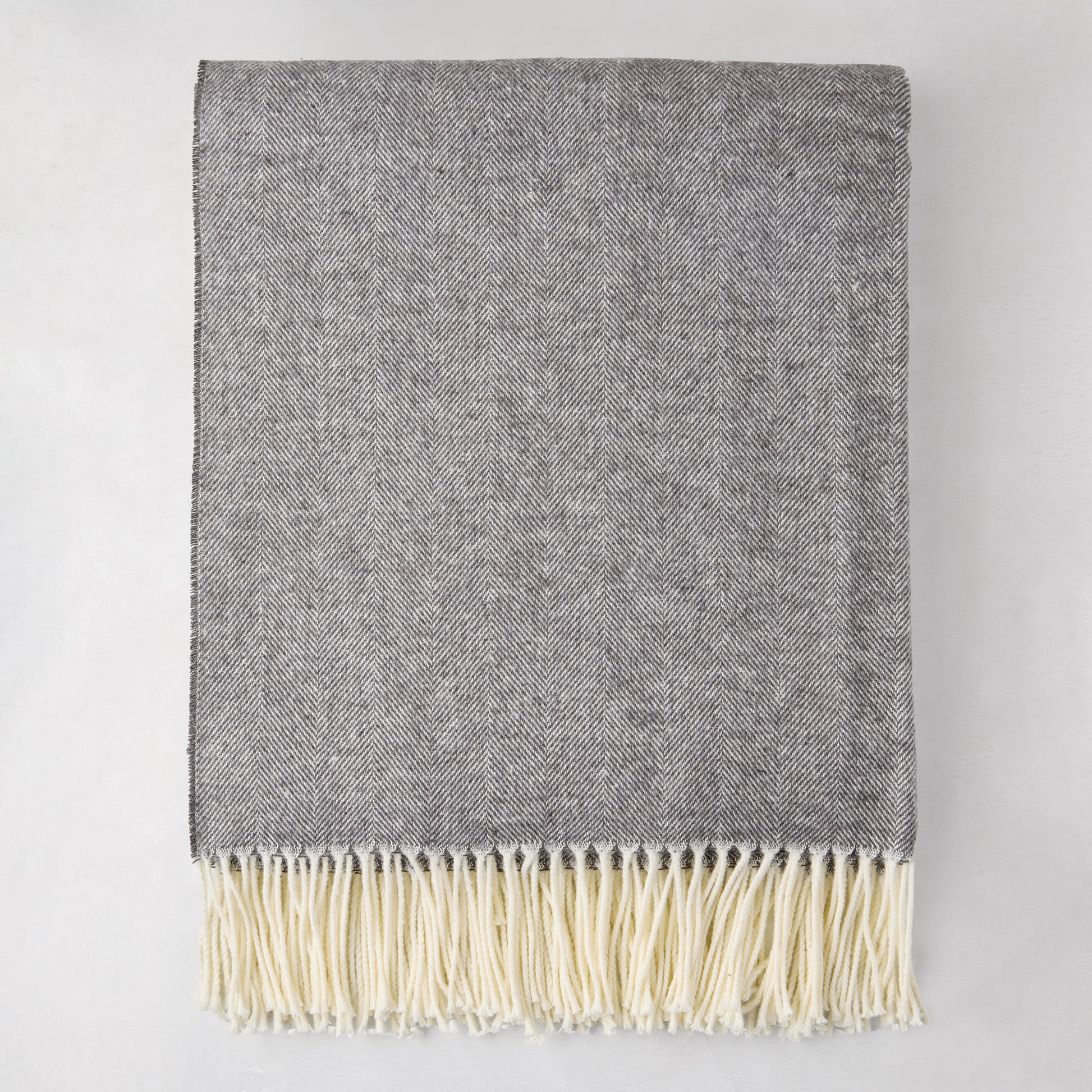 Charcoal Italian Herringbone Throw Blanket, 51"x67", with cream fringe, folded.