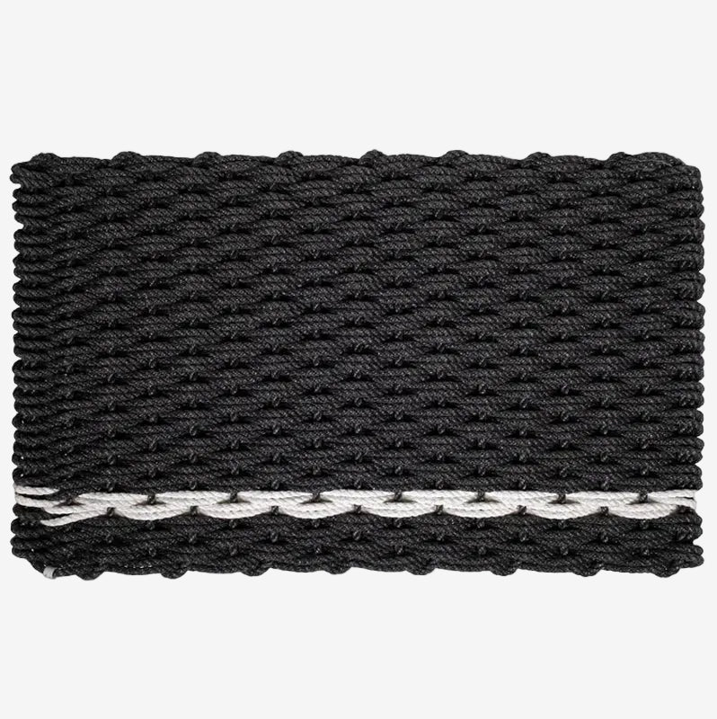 Handwoven charcoal rope doormat with a white pearl stripe along the bottom edge.