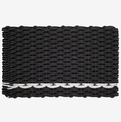 Handwoven charcoal rope doormat with a white pearl stripe along the bottom edge.
