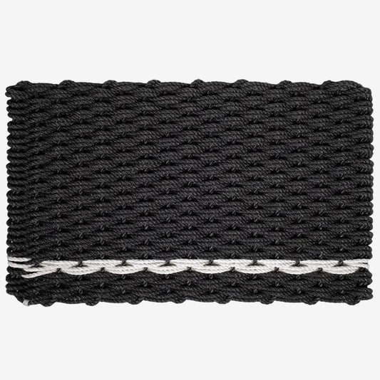 Handwoven charcoal rope doormat with a white pearl stripe along the bottom edge.