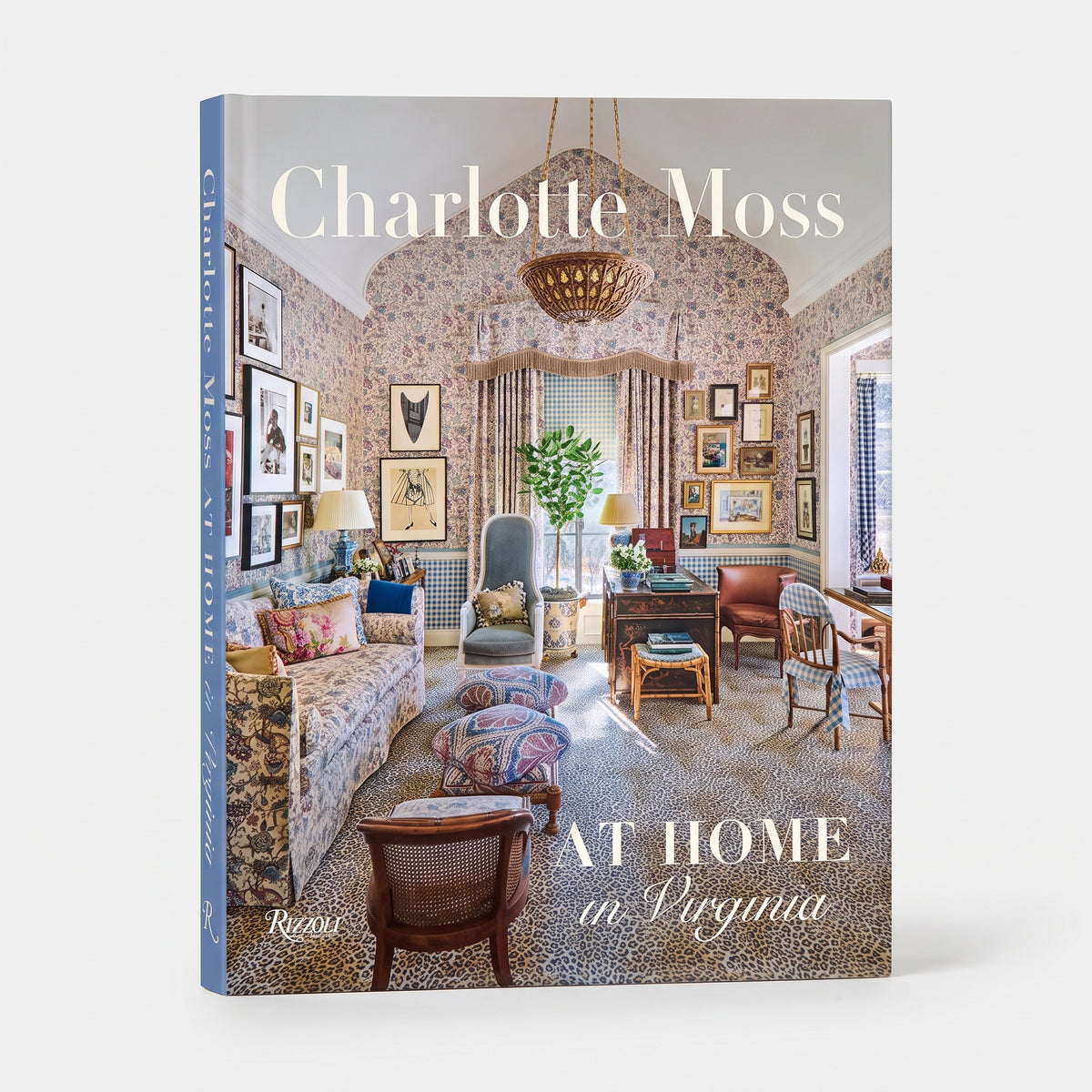 Charlotte Moss: At Home in Virginia coffee table book featuring a floral interior design cover with leopard print carpet.