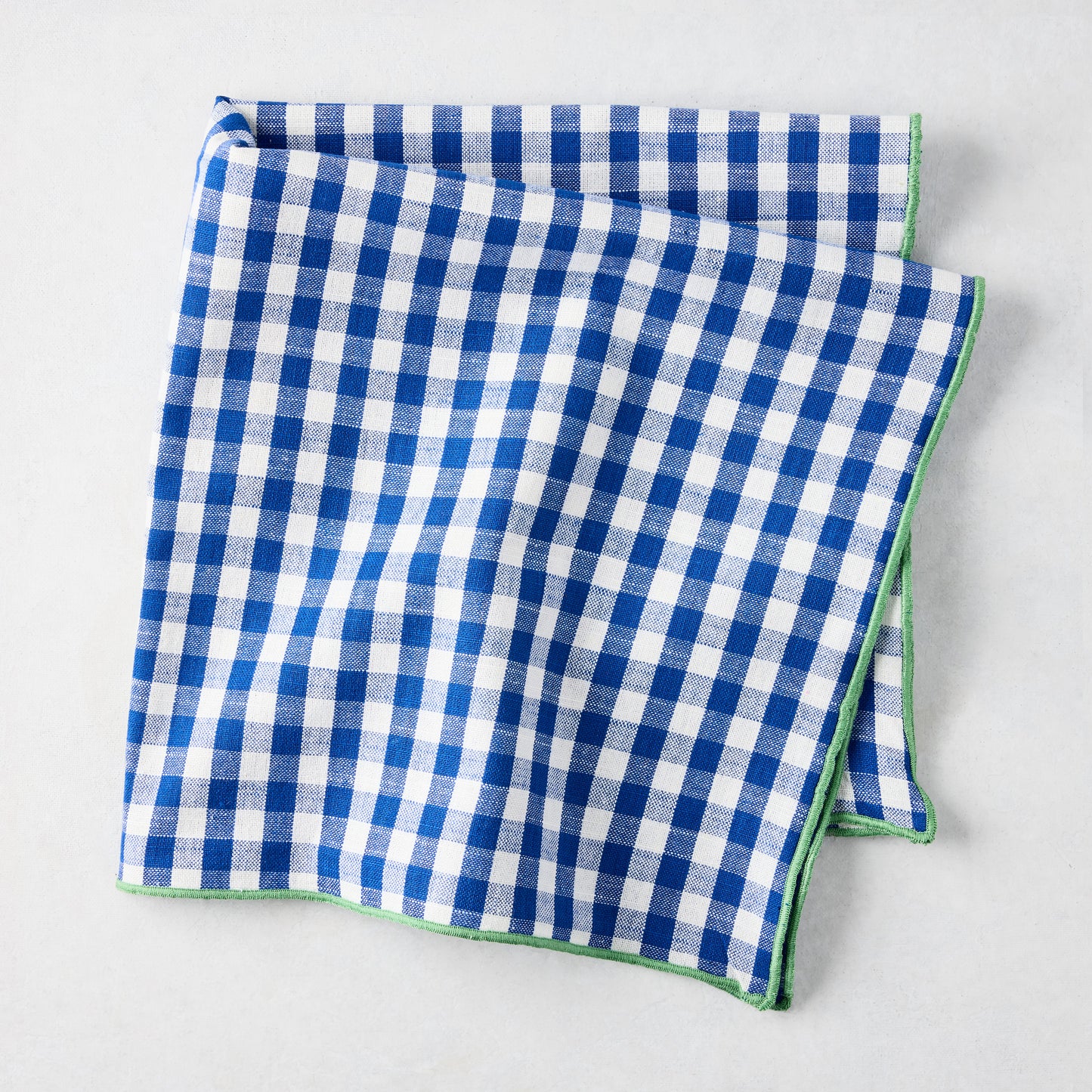 Chatham Blue Gingham Cotton Napkin, 22" square, with green embroidered trim.
