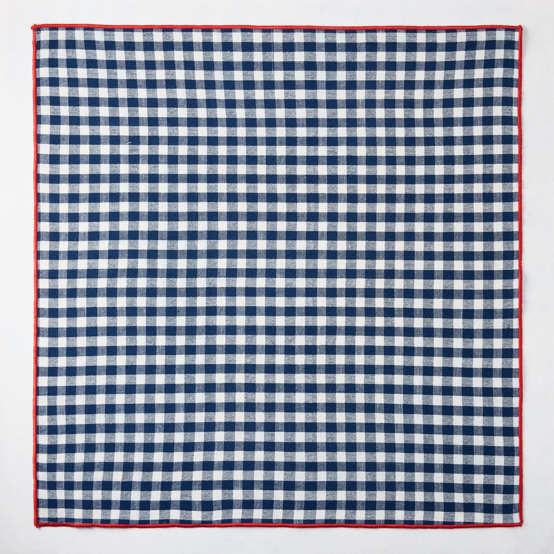 Chatham Navy Blue Gingham Cotton Napkin, 22" square, with red embroidered trim.