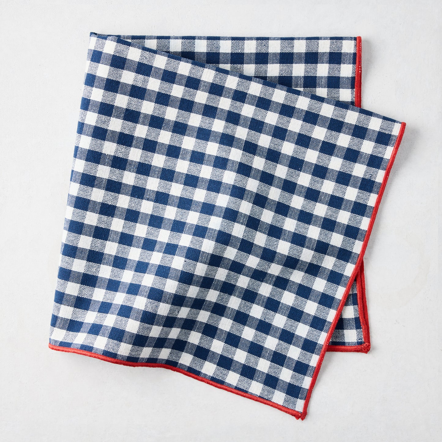 Chatham Navy Blue Gingham Cotton Napkin, 22" square, with red embroidered trim.