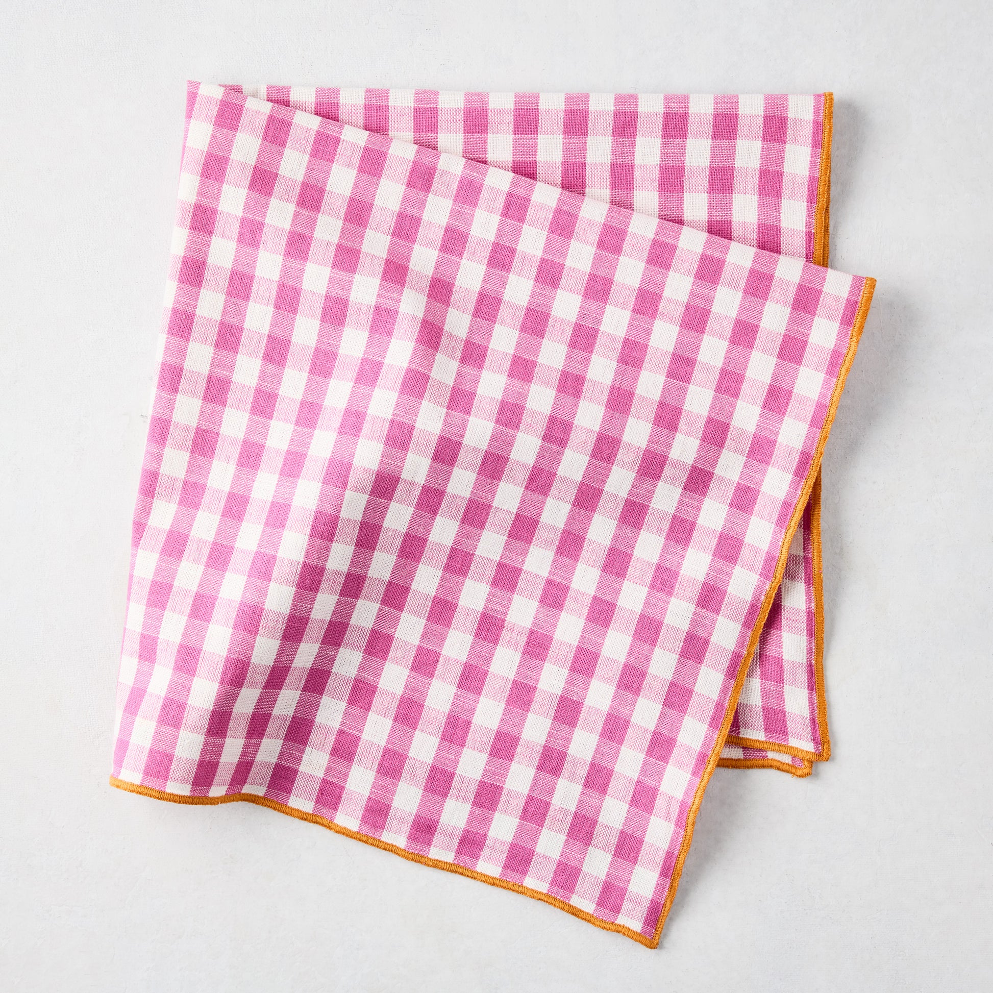 Chatham Pink Gingham Cotton Napkin with Orange Trim, folded.