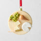3.25-inch round glass and resin cheese plate Christmas ornament with hand-painted grapes, pear, and cheese slices.