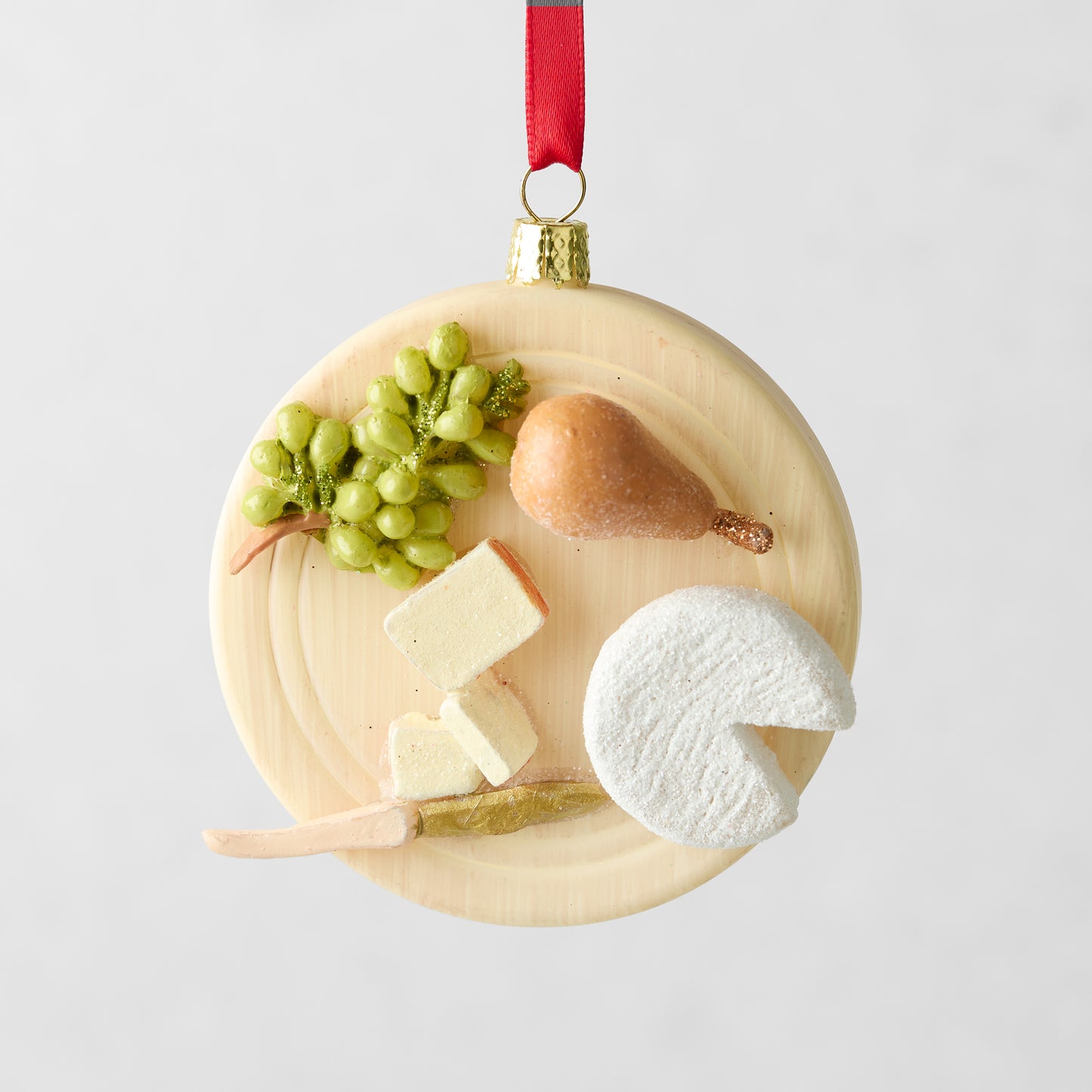3.25-inch round glass and resin cheese plate Christmas ornament with hand-painted grapes, pear, and cheese slices.