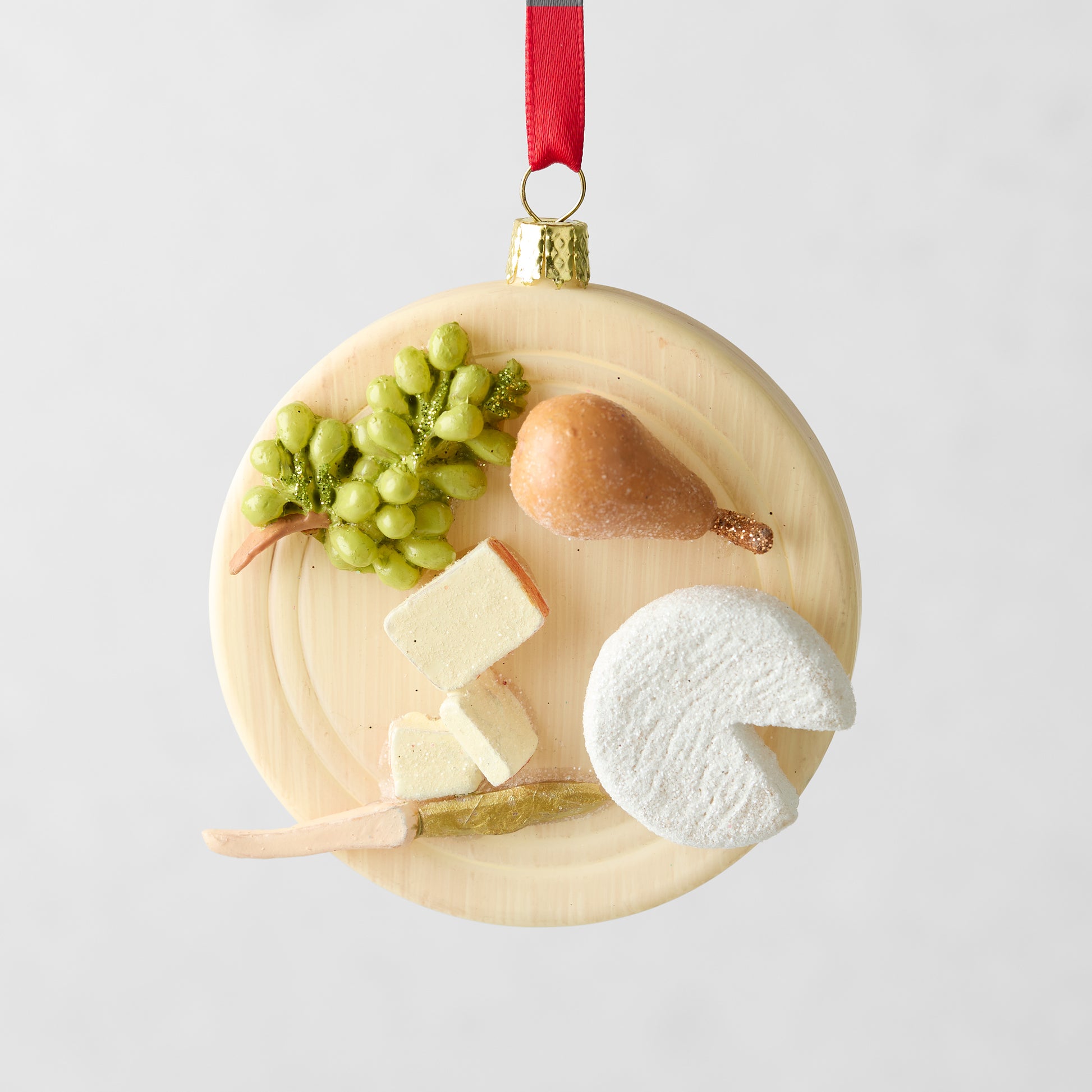 3.25-inch round glass and resin cheese plate Christmas ornament with hand-painted grapes, pear, and cheese slices.