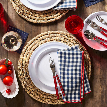 Cherry red 5-piece bistro flatware set with stainless steel and acrylic handles on a rustic table setting.