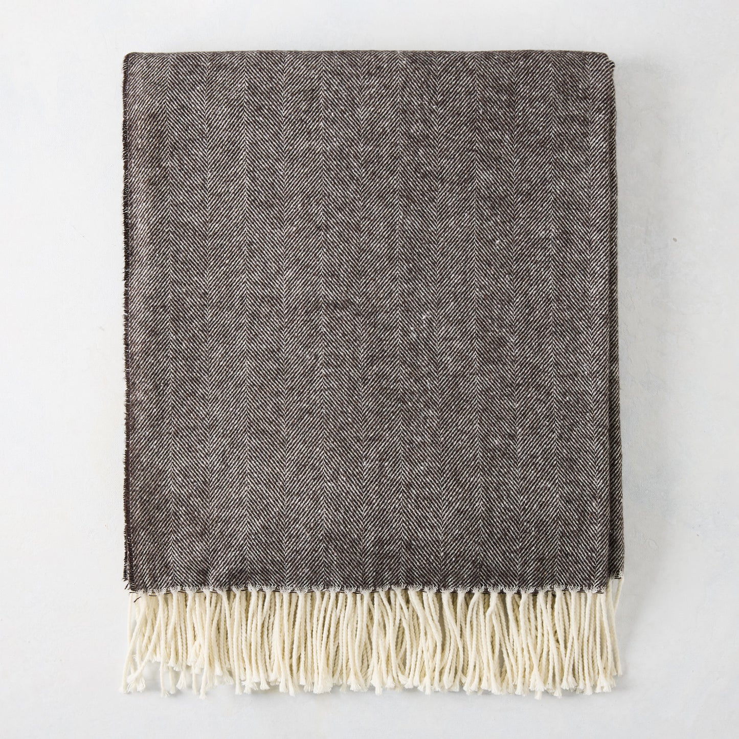 Chestnut brown Italian herringbone throw blanket with cream fringe.