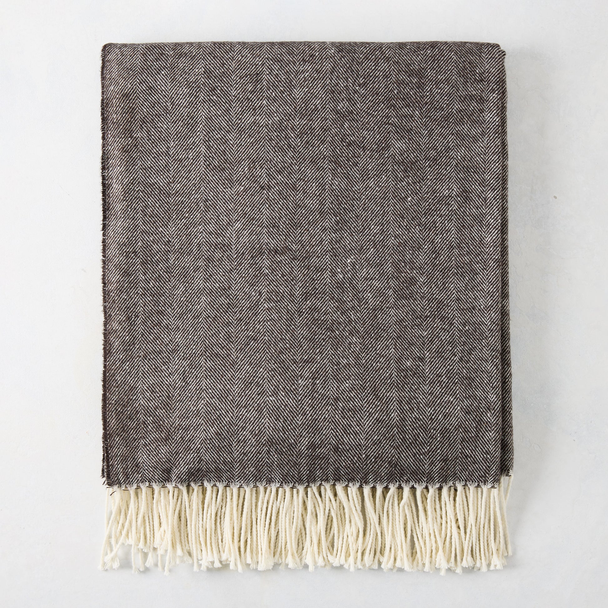 Chestnut brown Italian herringbone throw blanket with cream fringe.