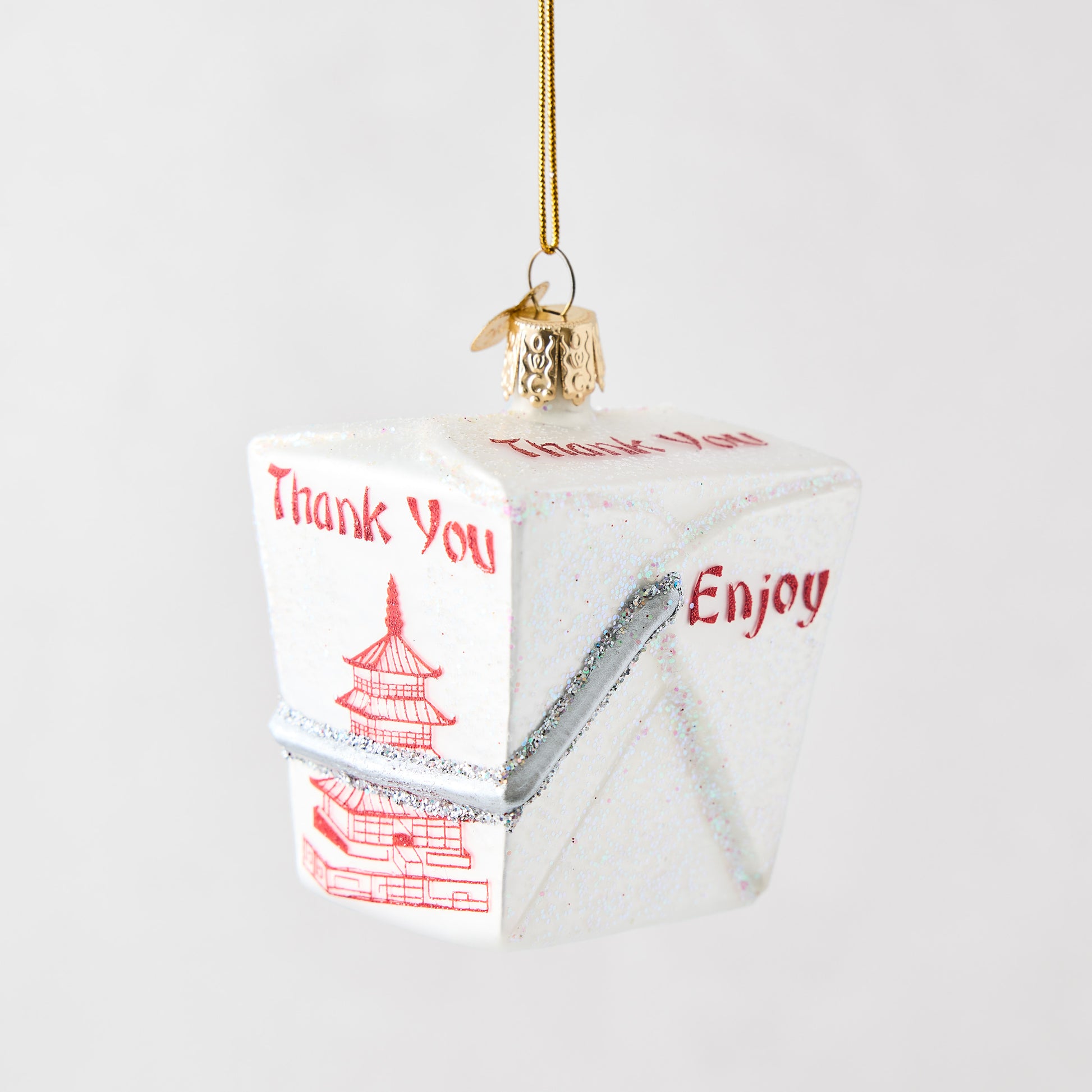 Hand-painted white glass Chinese takeout box ornament with red pagoda design, glitter accents, and gold hanging string.