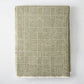 Chive green Sutton Houndstooth throw blanket, 51"x67" cotton-acrylic blend with raw edge.