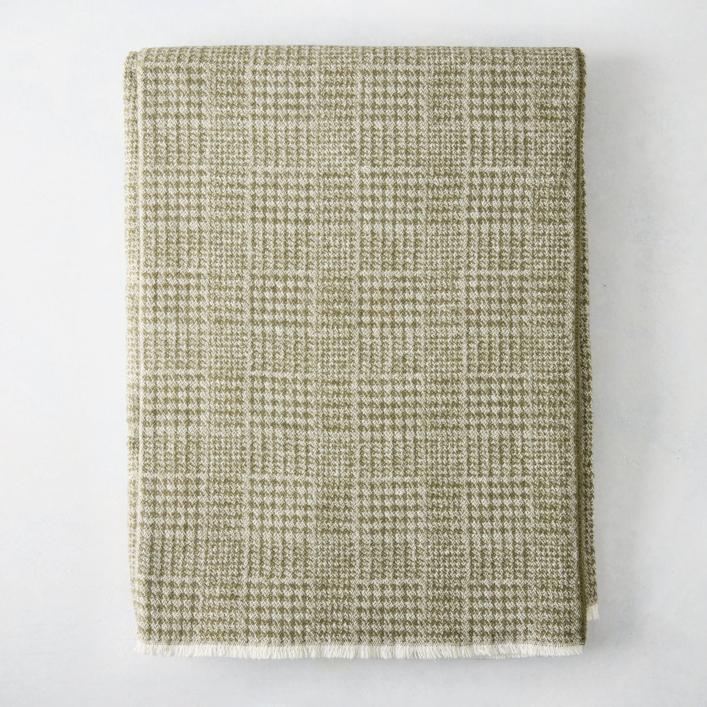 Chive green Sutton Houndstooth throw blanket, 51"x67" cotton-acrylic blend with raw edge.
