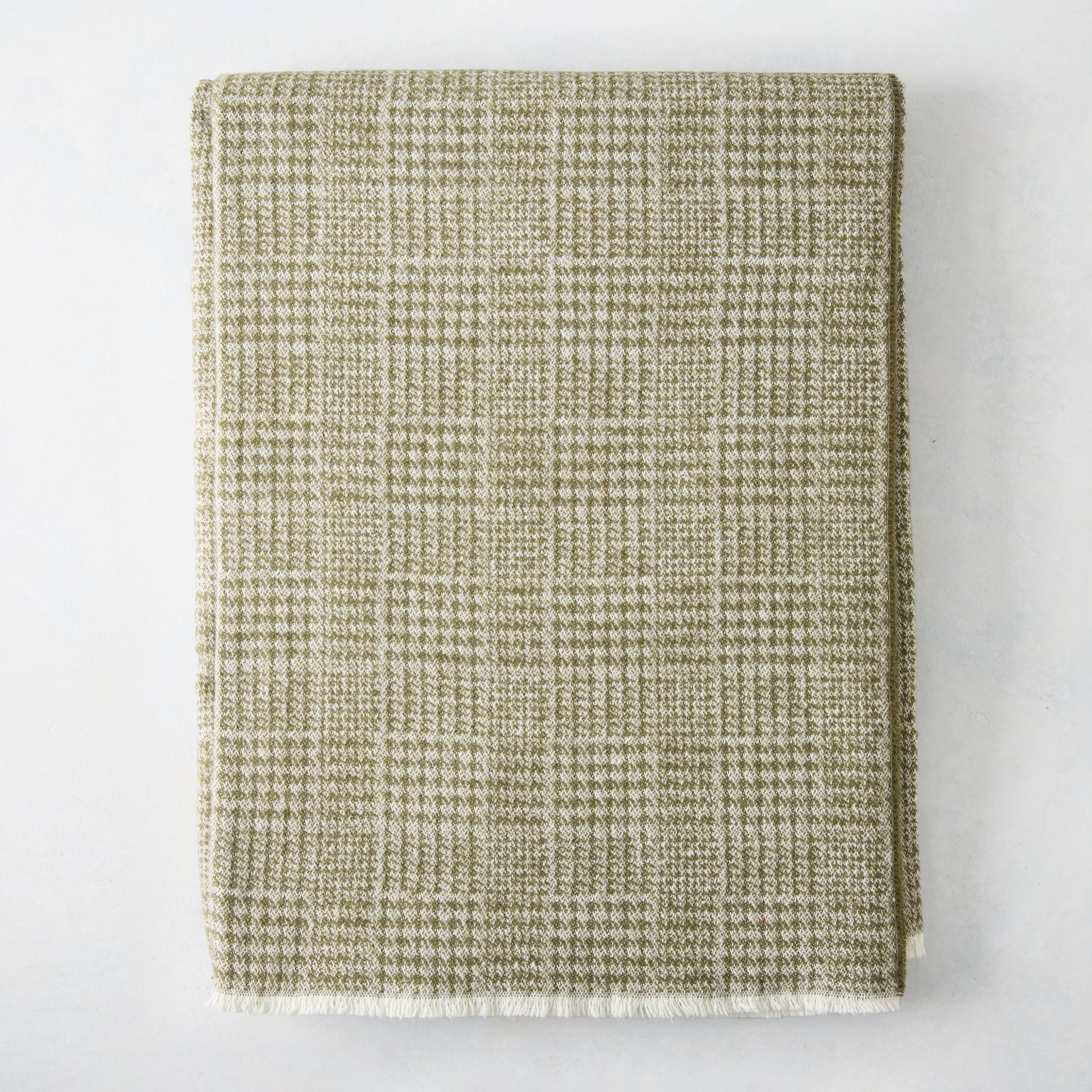 Chive green Sutton Houndstooth throw blanket, 51"x67" cotton-acrylic blend with raw edge.