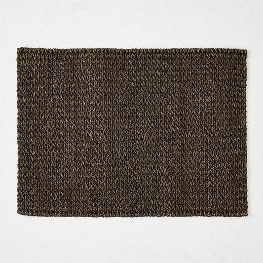 Chocolate brown rectangular placemat hand-woven from 100% abaca fiber, 19 by 14 inches.